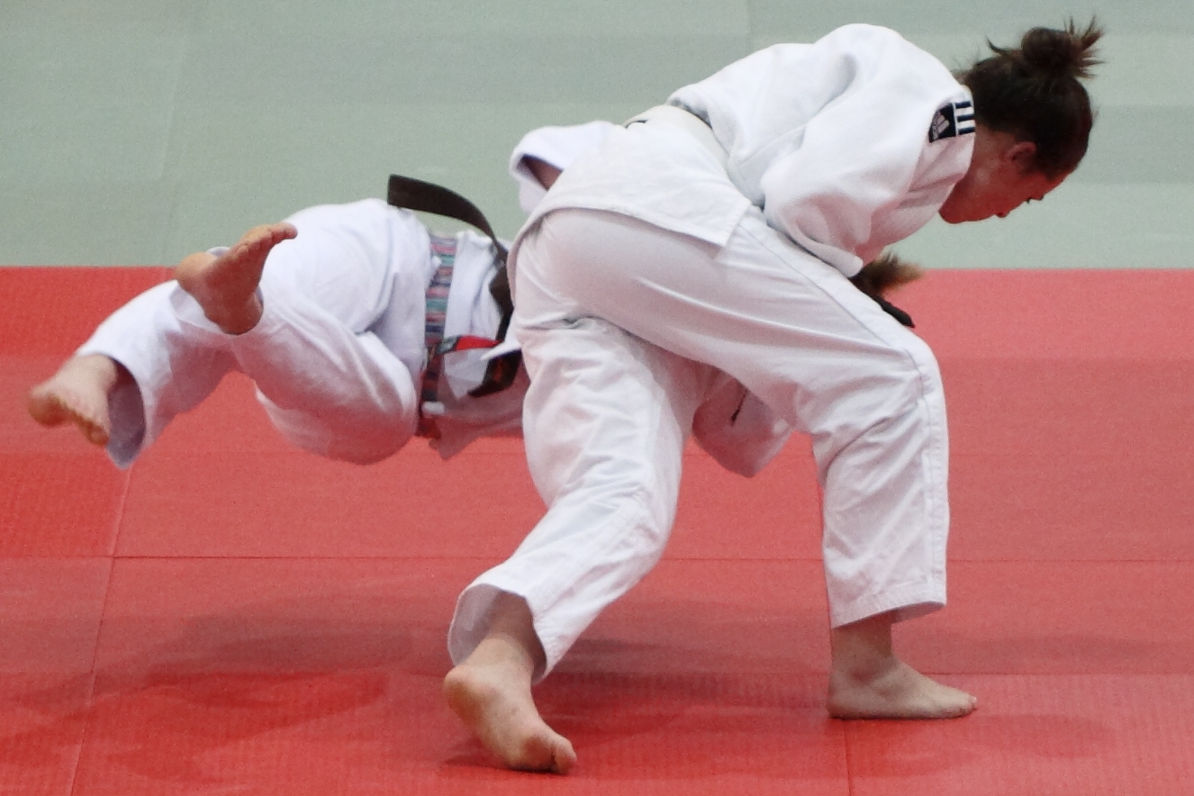 Judo competitor executing a throw during competition that earns a waza-ari score